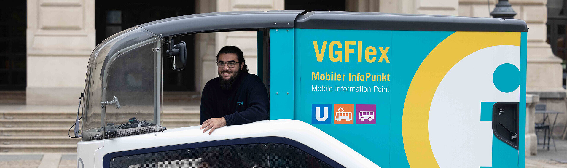 Ein lächelnder VGF-Mitarbeiter schaut aus dem "Cockpit" des Lastenfahrrads VGFlex